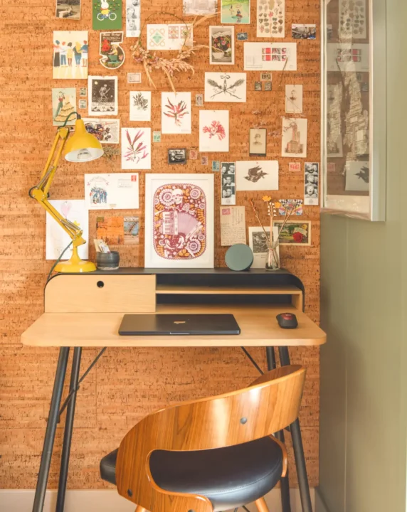 Office set up in front of cork wall interior Little Green Room