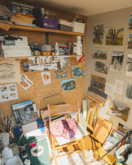 Interior of Sue's room with paintings pinned to the walls.