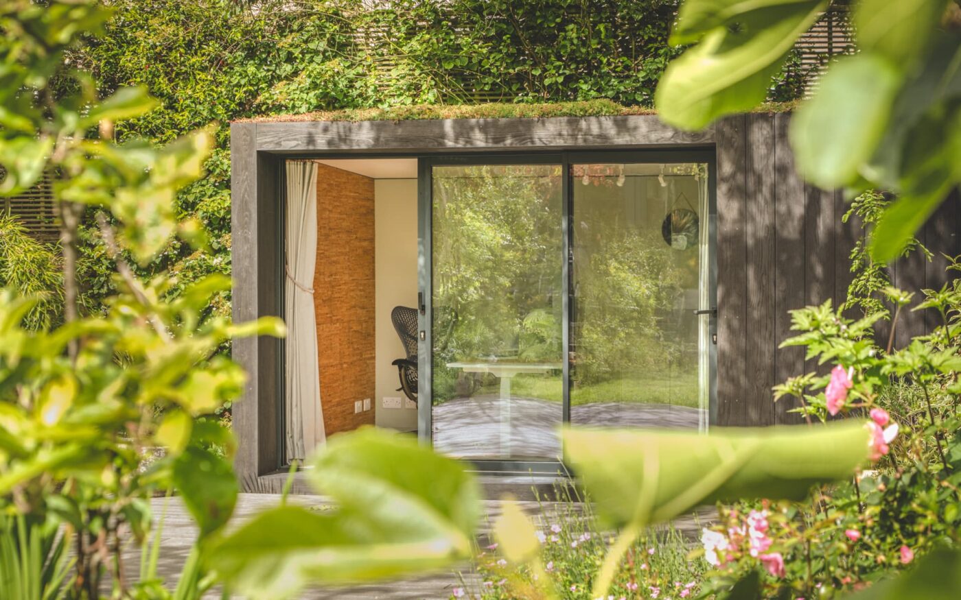 Little Green Room in burnt cedar with plants in foreground