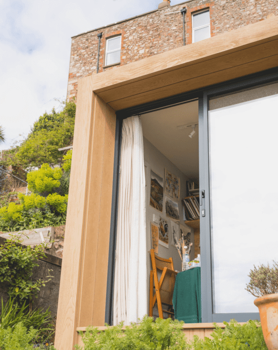 Exterior of Little Green Room with the sliding doors open.