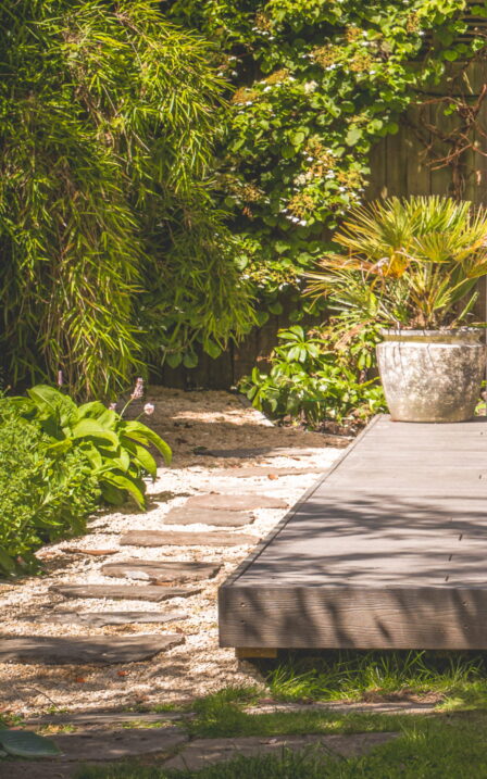 Stone steps alongside the decking in burnt cedar.