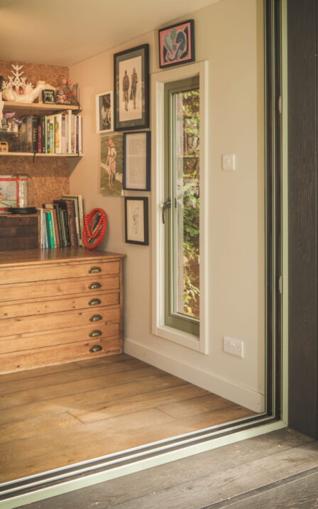Little Green Room with oak floor and decking. In burnt cedar with green mist frames.