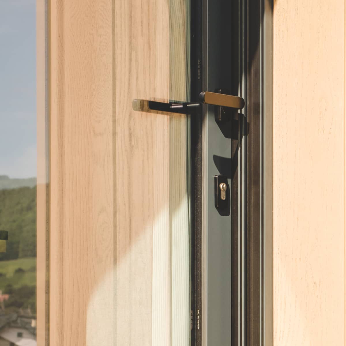 Close up of door handle on Little Green Room in golden oak