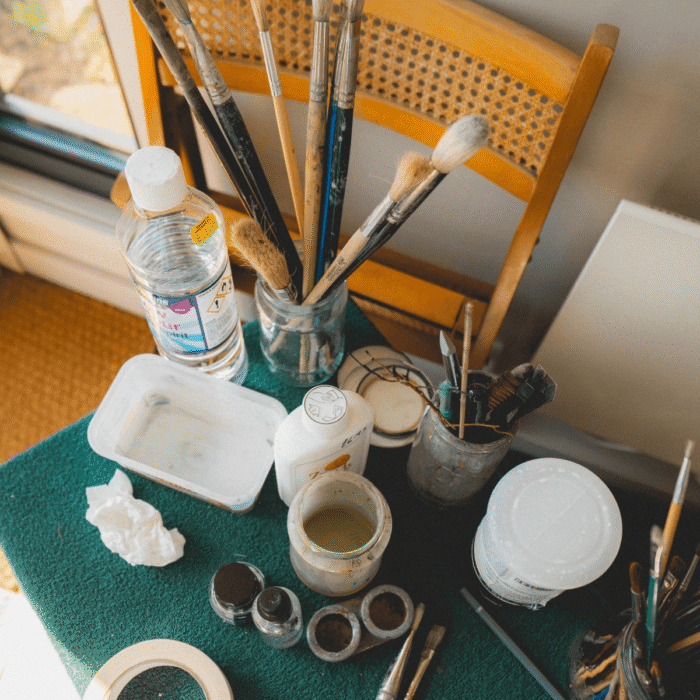 Sue's paintbrushes on a table on in her Little Green Room.