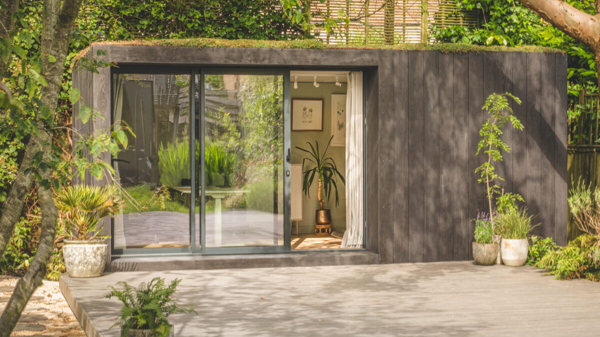 Exterior of Little Green Room in burnt cedar with additional decking.